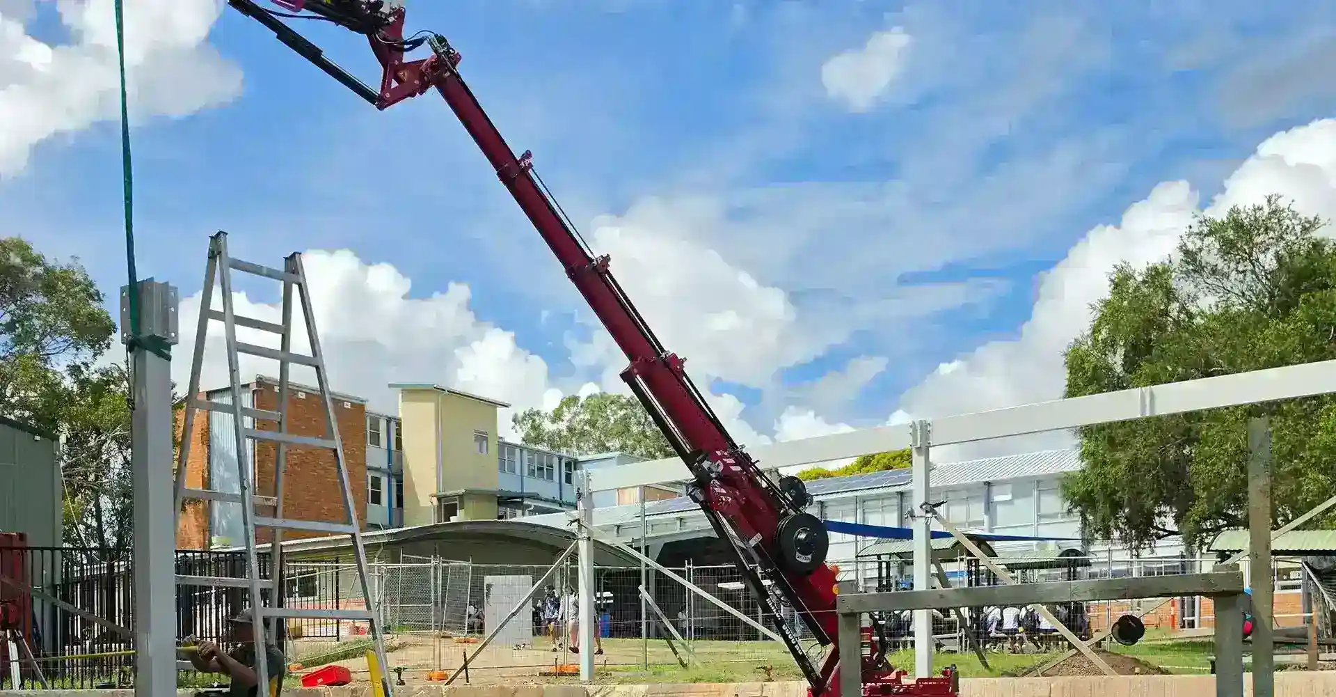 Compact crawler crane executing precise lifting under strict safety standards on a constrained civil infrastructure job