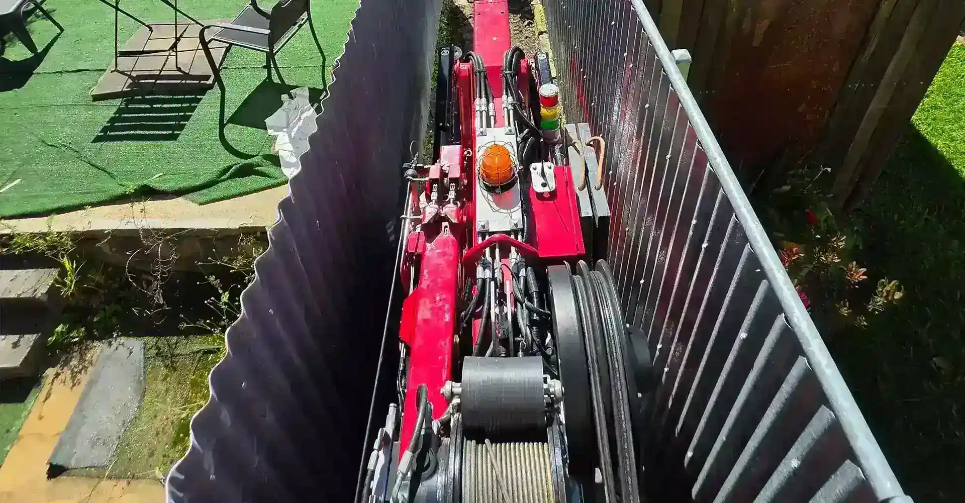 Narrow access mini crane maneuvering effortlessly through a tight doorway entrance