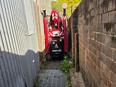 Compact crane working efficiently inside a narrow restricted-access site layout